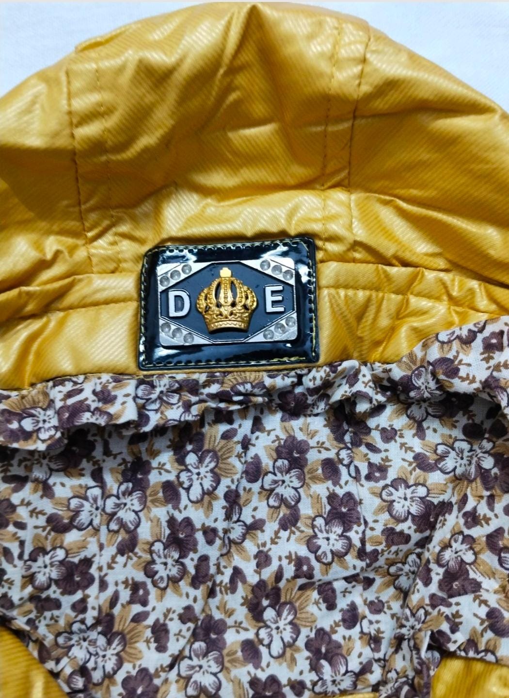 A stylish mustard yellow winter jacket designed for 7-year-old girls.